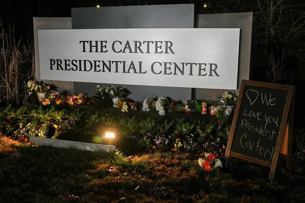 Mourners Place Peanuts, Peaches Outside of Carter Center Following Jimmy Carter’s Death ArticlePure